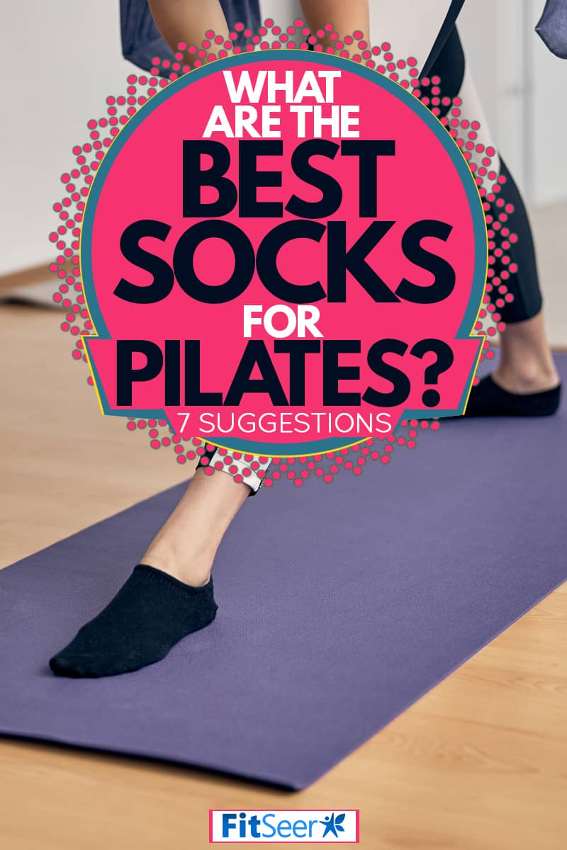 Woman stretching her legs and limbs on a yoga mat before starting her Pilates exercise, What Are The Best Socks For Pilates? [7 Suggestions]