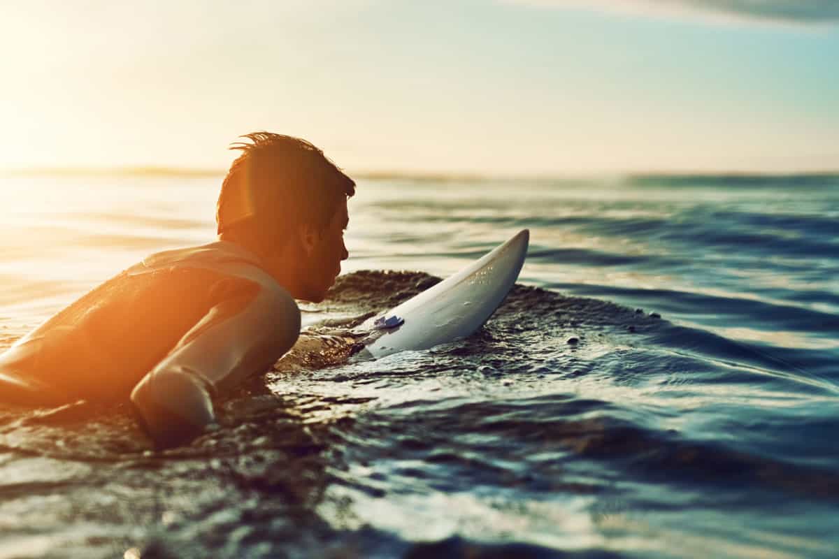 Shot of a young boy out surfing