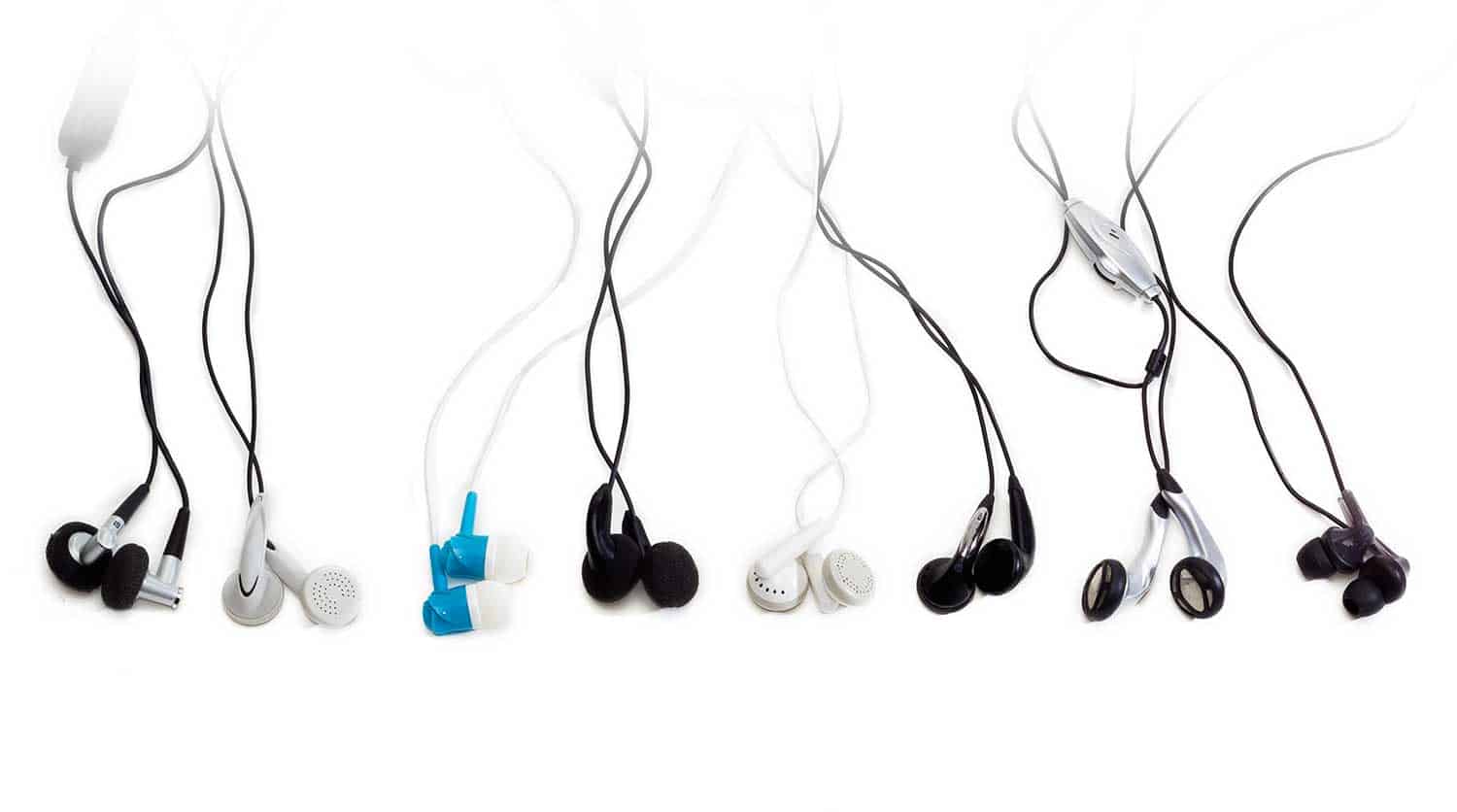 Several various earbuds on a light background