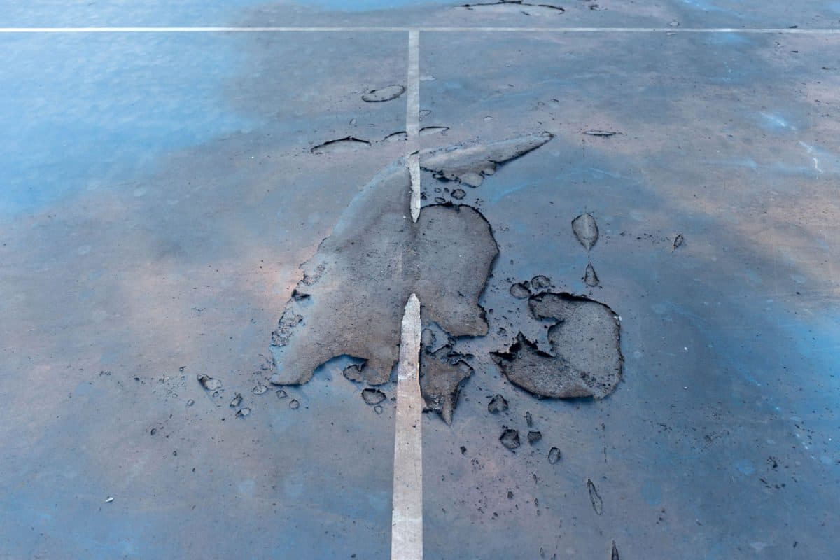 Paint peeling off a tennis court