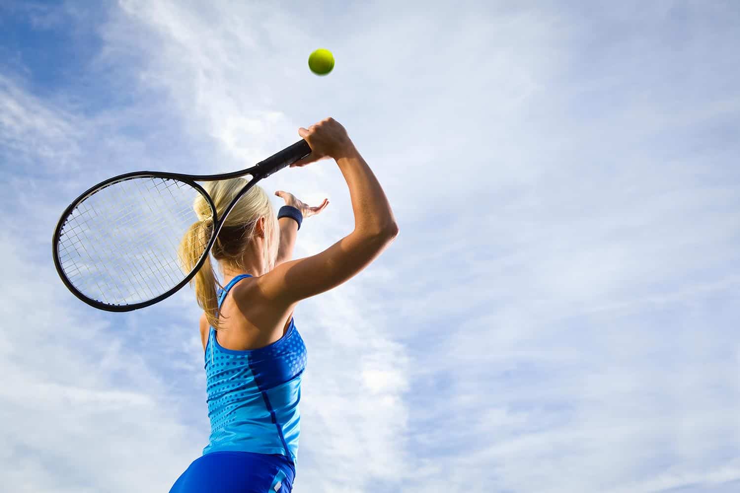 Woman on tennis court playing tennis