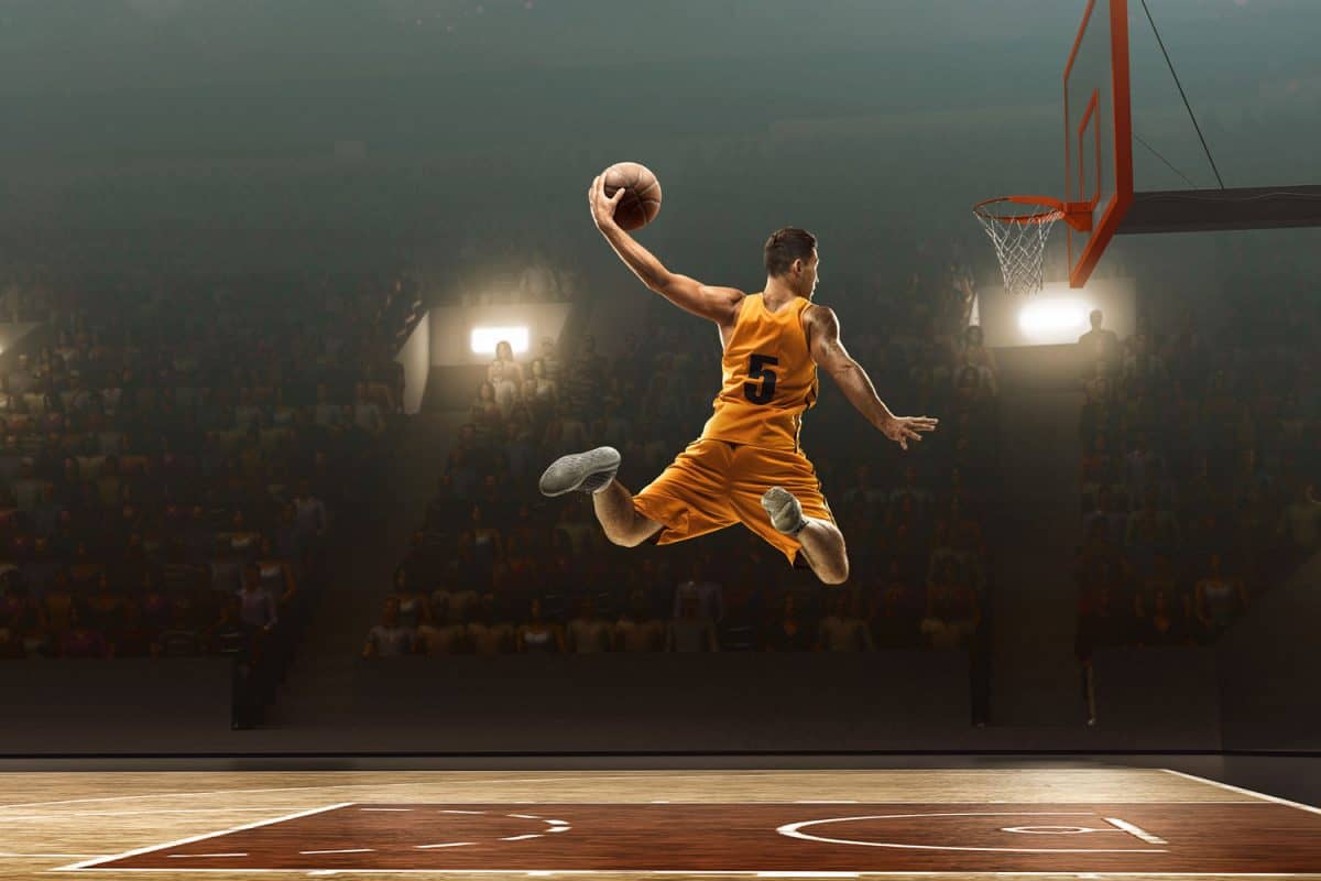 A basketball player going for a dunk