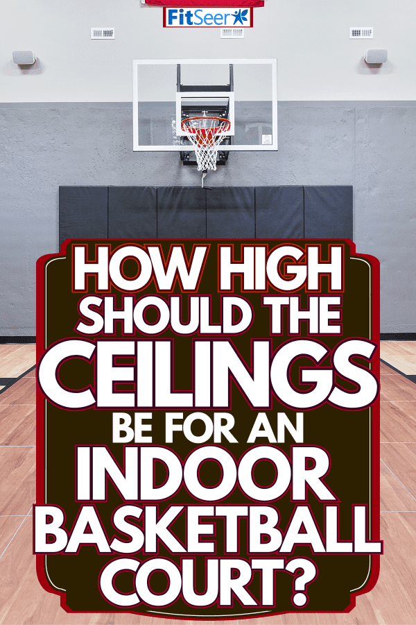 An indoor basketball with hardwood flooring and the American Flag on the wall, How High Should The Ceiling Be For An Indoor Basketball Court?
