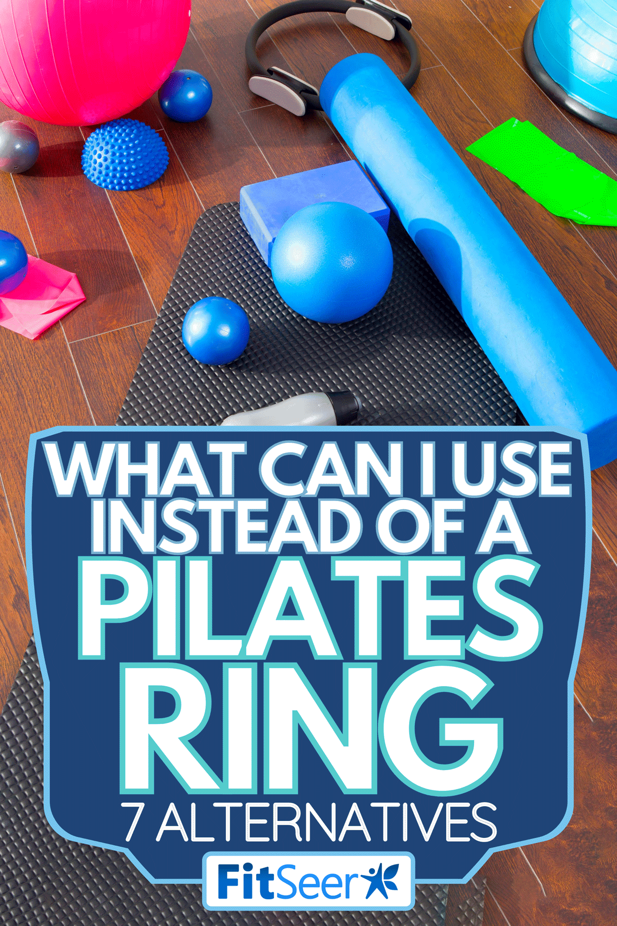 An Aerobic Pilates stuff like mat balls roller magic ring rubber bands on wooden floor, What Can I Use Instead of a Pilates Ring [7 Alternatives]