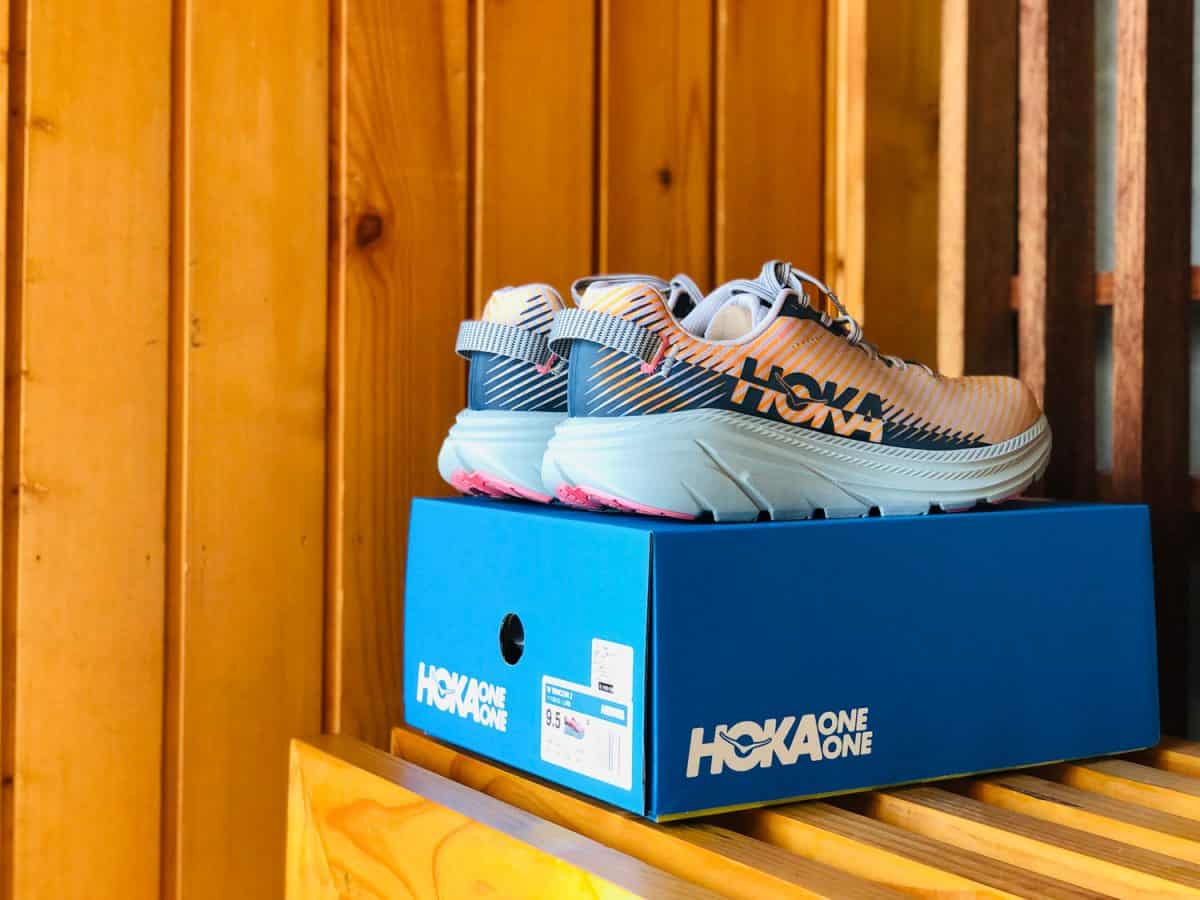 new running shoes branded Hoka One One - Rincon 2 are on the wooden shelf