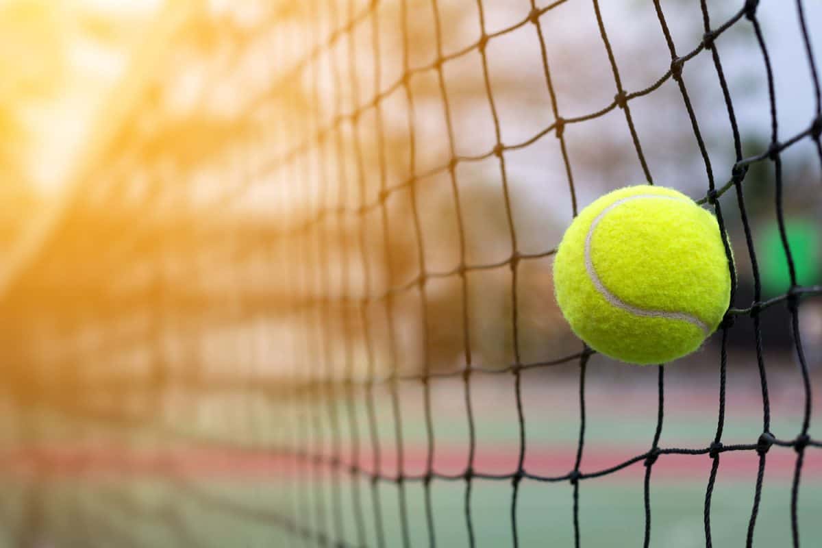 A tennis ball hitting the net