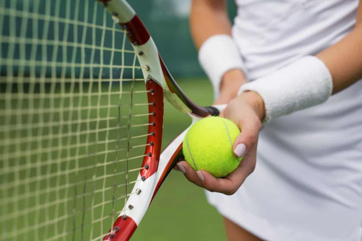 Tennis player holding a tennis ball before serving