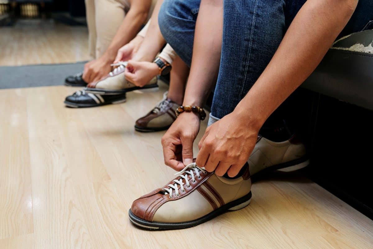 A group of people wearing bowling shoes
