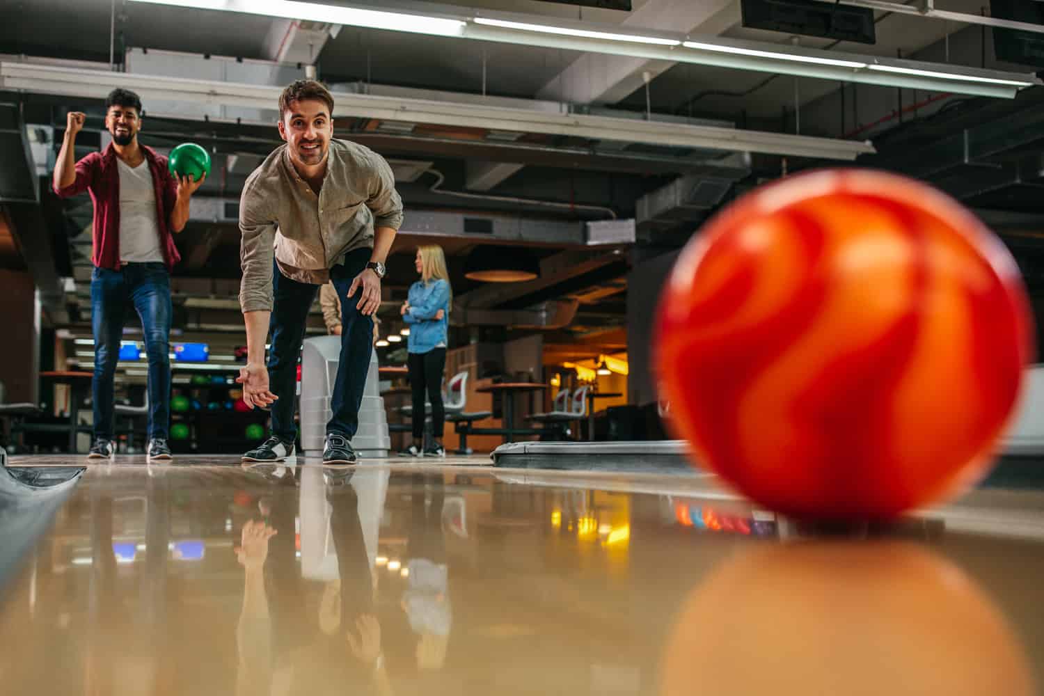 Shot of an attractive young man throwing a bowling ball