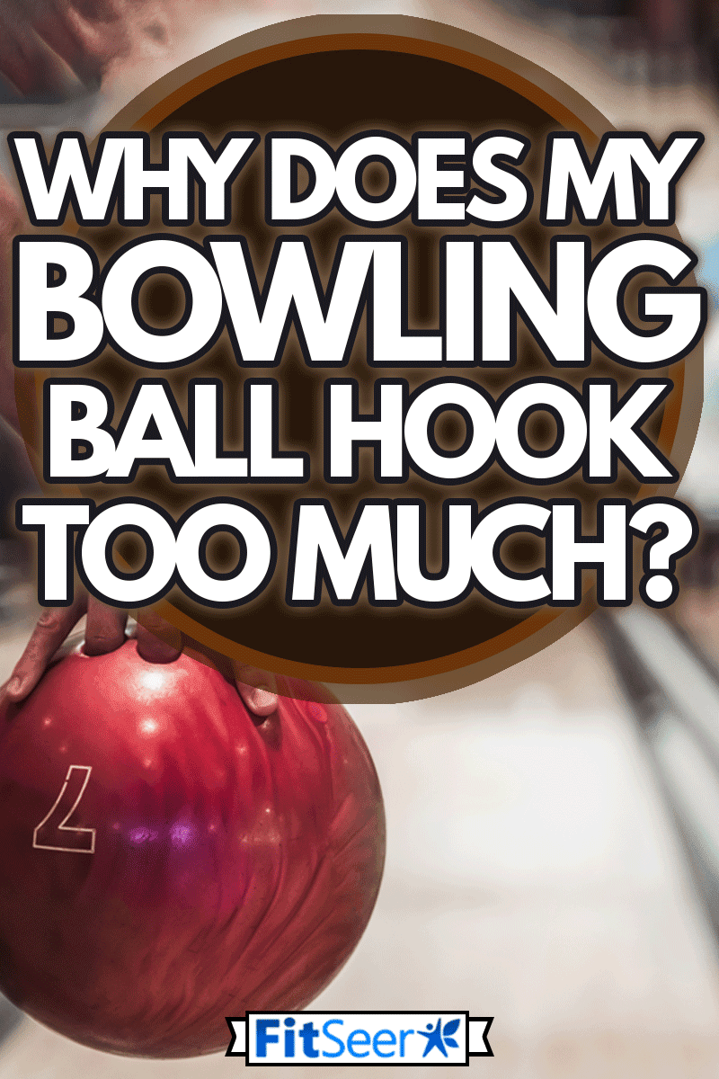 Man's hand holding a red bowling ball ready to throw it, Why Does My Bowling Ball Hook Too Much?