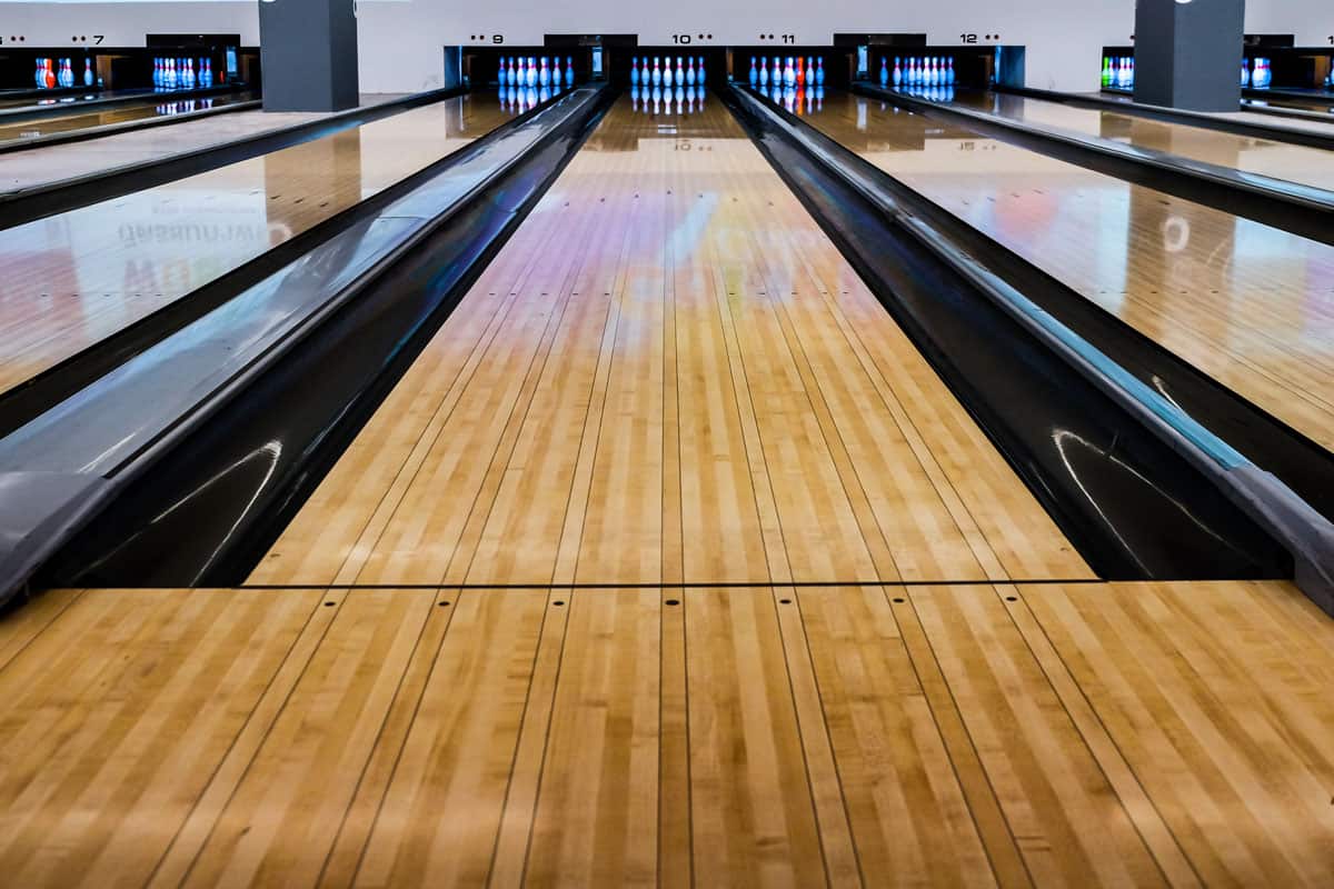 bowling pins bowling balls in a row