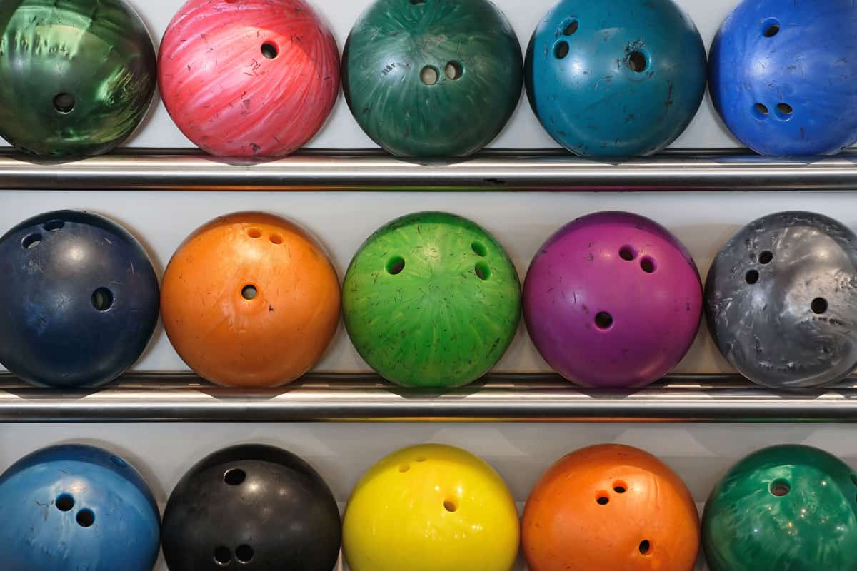 rack of old worn bowling balls.