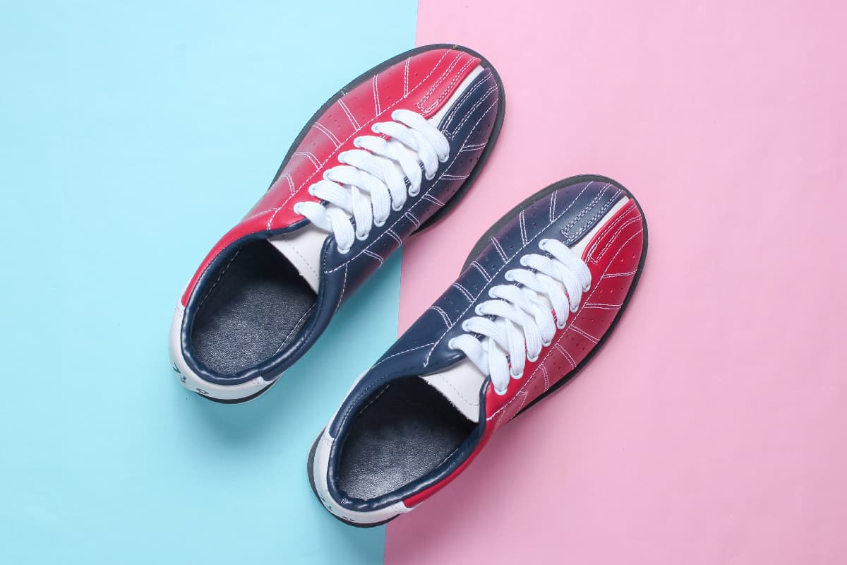 Bowling shoes on a pink-blue pastel background